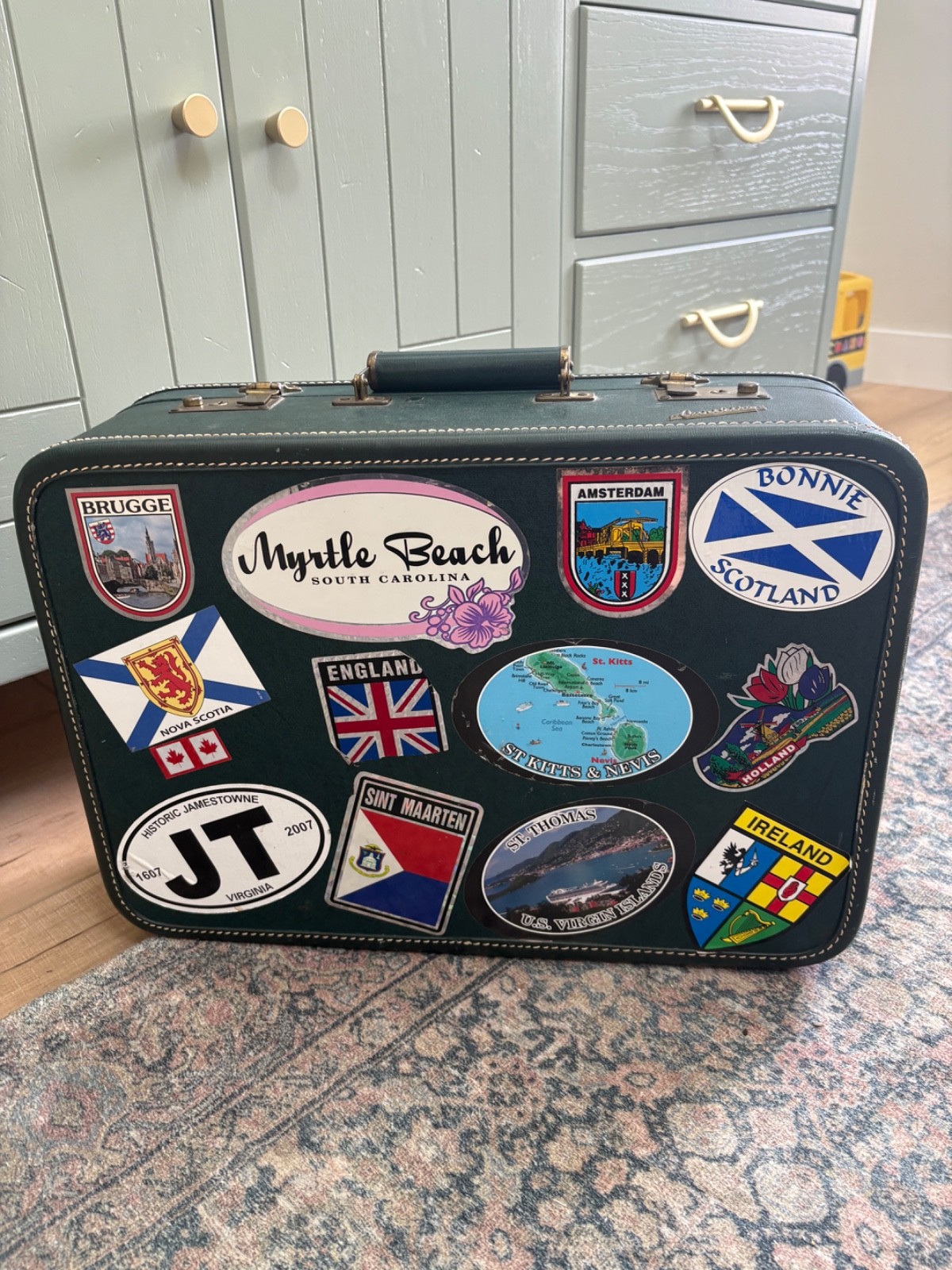 Vintage Carilite hardcover suitcase green 1970s with travel stickers from Europe