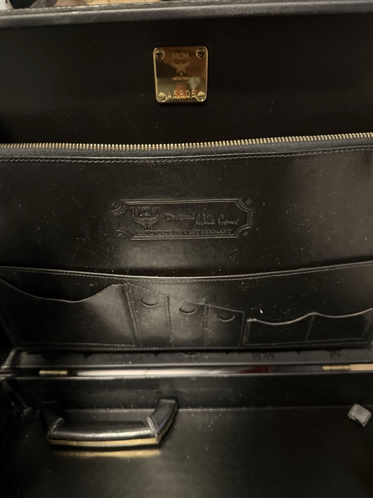 MCM VINTAGE travel case. Heritage series in black with gold-colored fittings.