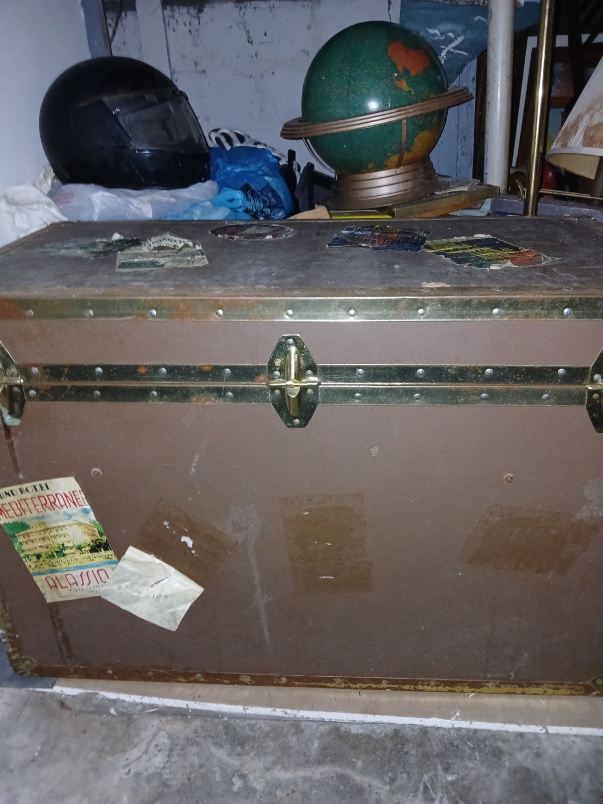 Set Of 4 Vintage Traveling Suitcases By “Keith ” with brown wooden trunk.