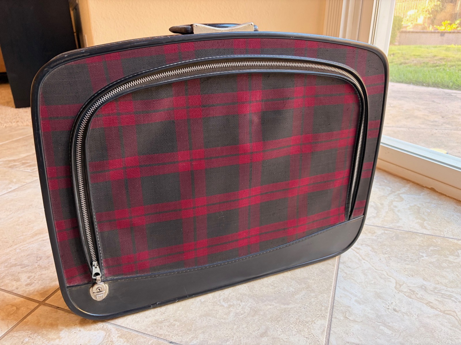 vintage-style soft-sided suitcase with red and black plaid pattern