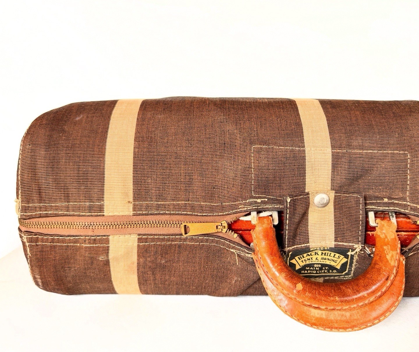 Vintage leather suitcase with canvas cover
