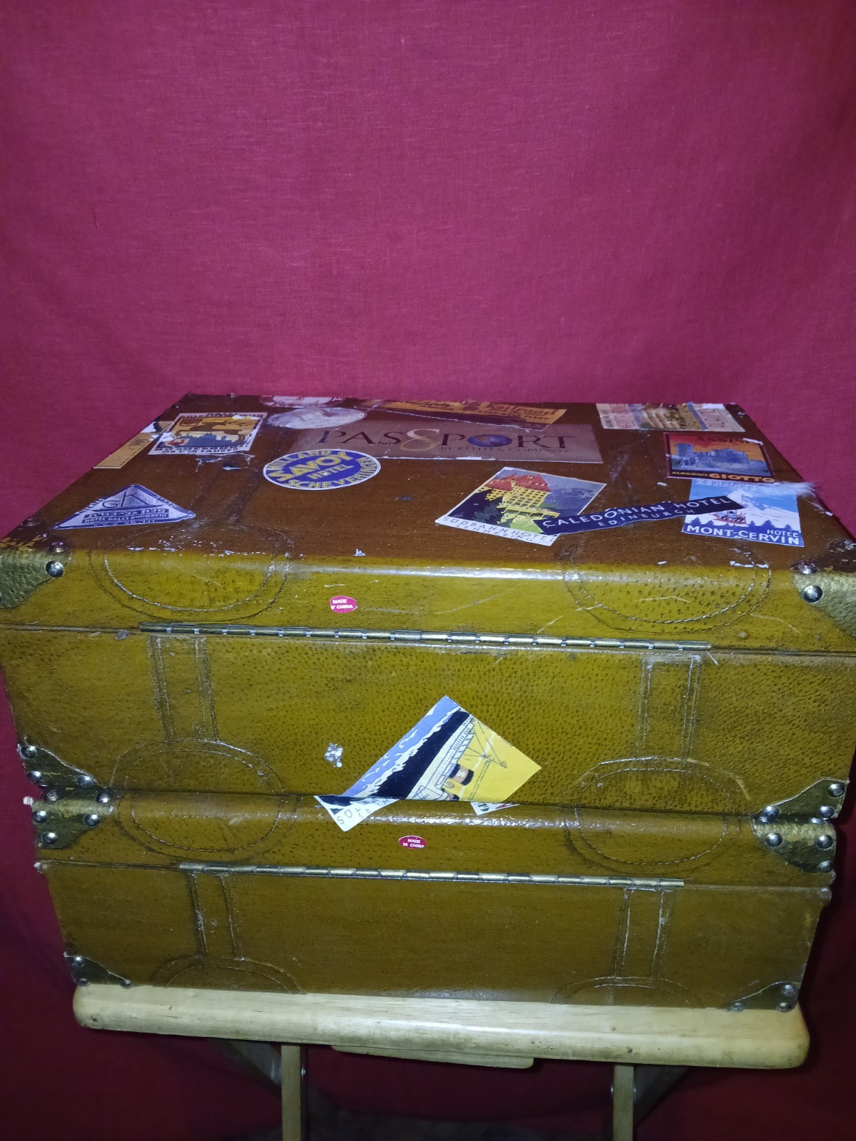 Set Of 4 Vintage Traveling Suitcases By “Keith ” with brown wooden trunk.